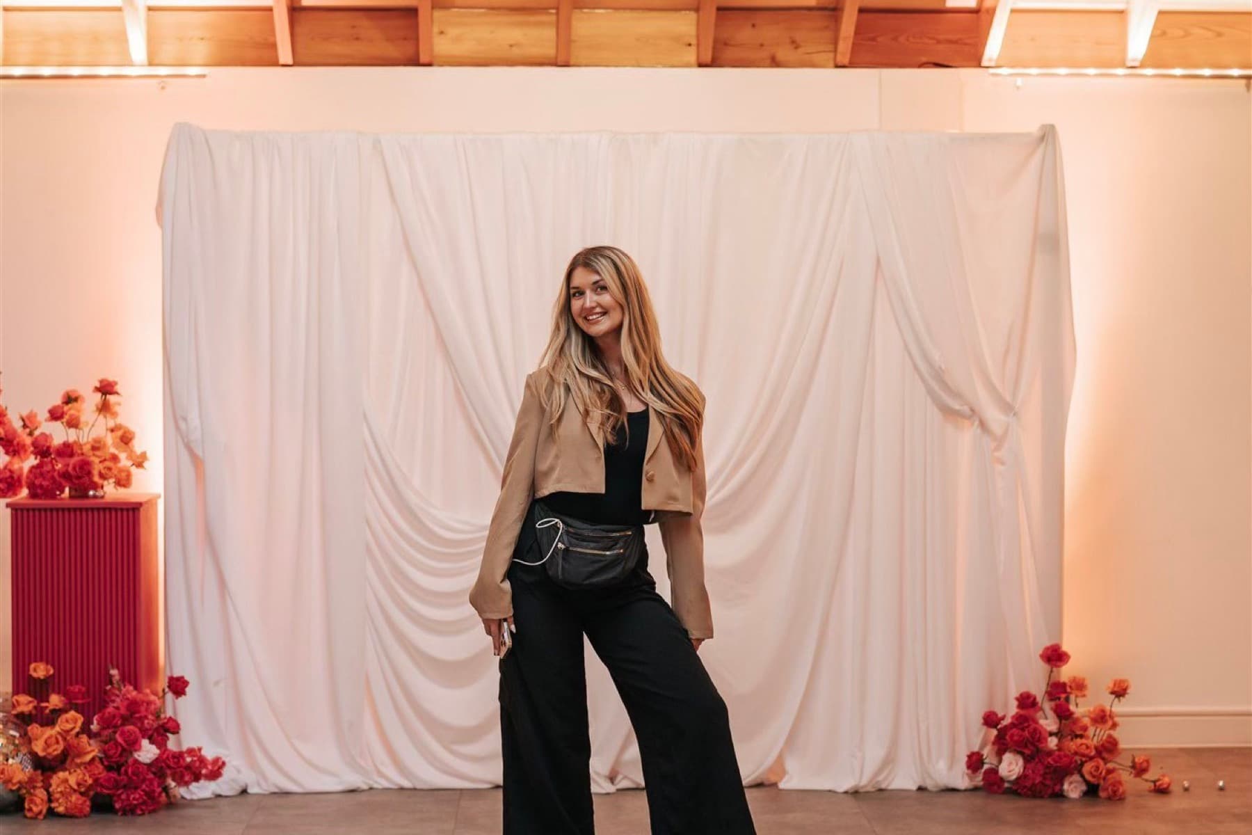 A creator at a styled event with floral installations