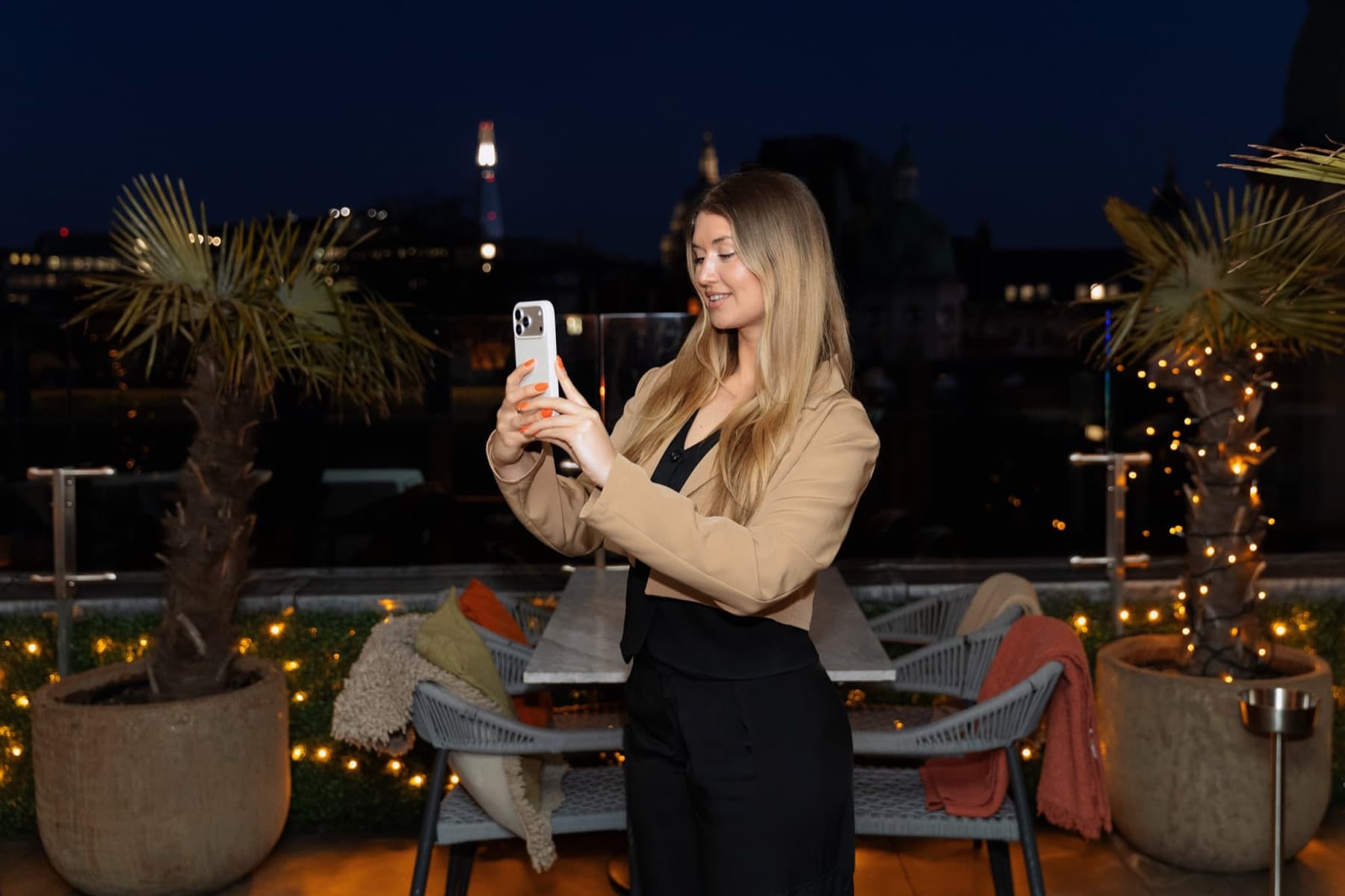 A photographer capturing content on location at dusk